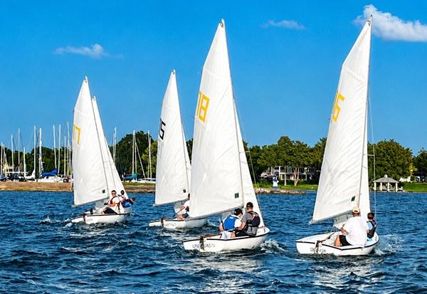 Four Flying Junior dinghies racing on Lake Ray Hubbard at Rush Creek Yacht Club