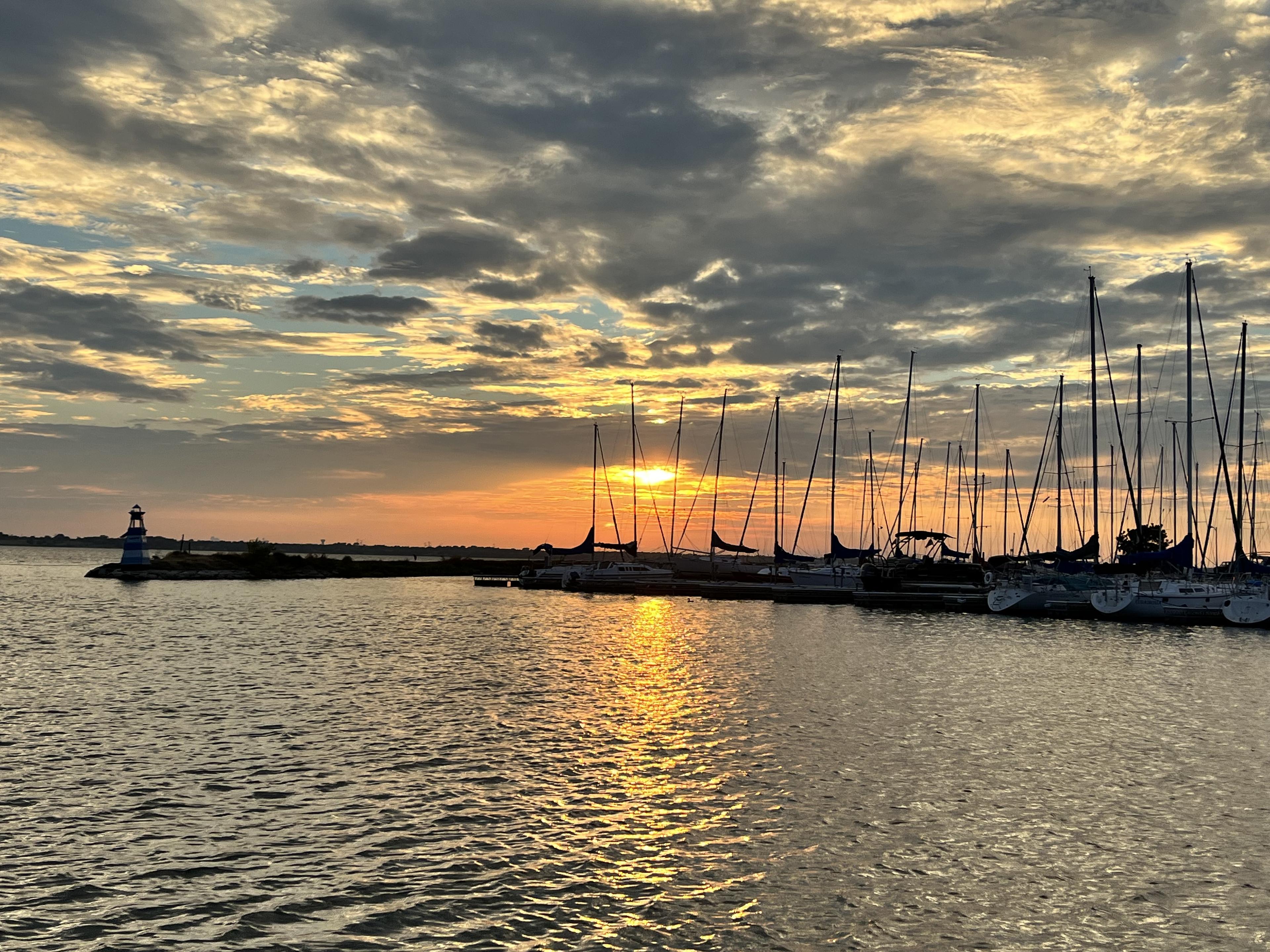 Rush Creek harbor at sunset with the lighthouse at golden hour