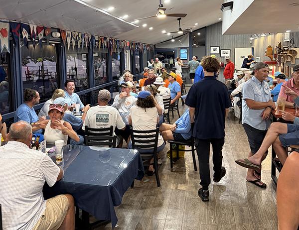 Rush Creek Yacht Club clubhouse interior filled with members during a post-race gathering