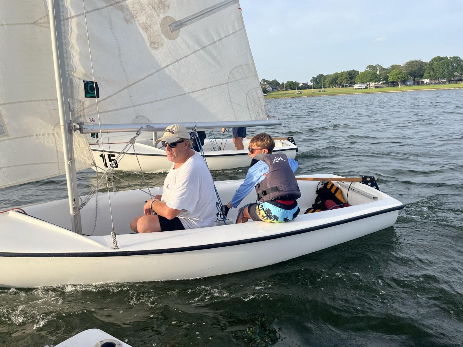 Adult and junior crew sailing a Flying Junior dinghy on Lake Ray Hubbard