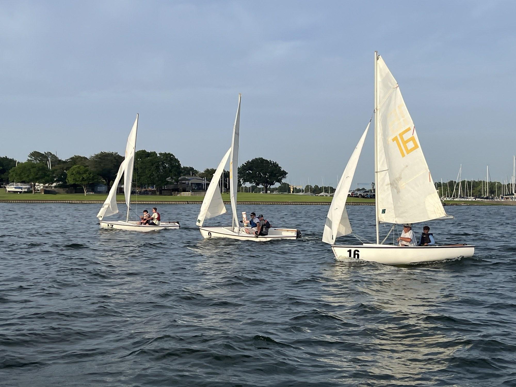 Three Flying Junior dinghies sailing on Lake Ray Hubbard at Rush Creek Yacht Club