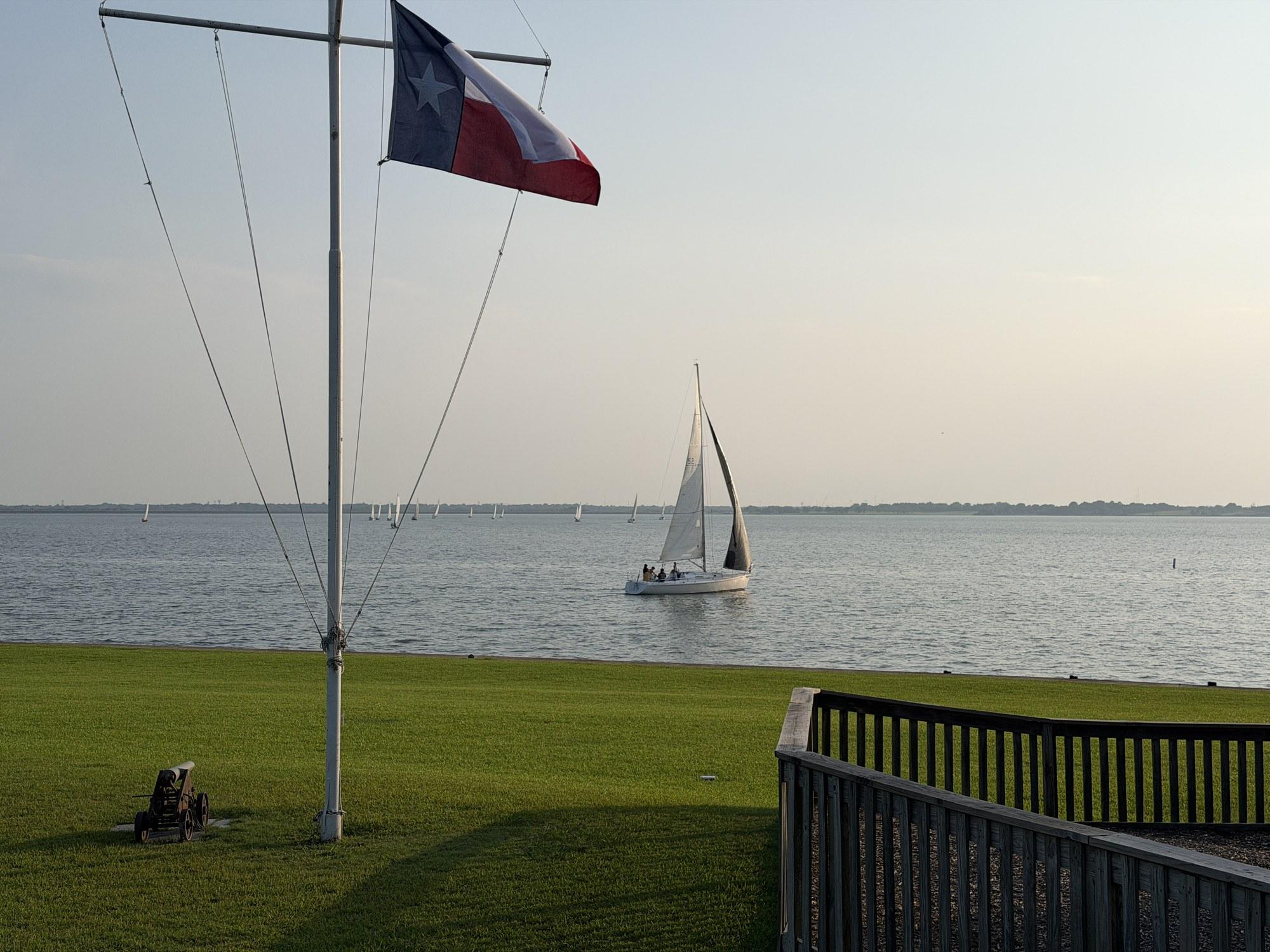 IC24 keelboat sailing past the Rush Creek Yacht Club lawn during Wednesday night racing