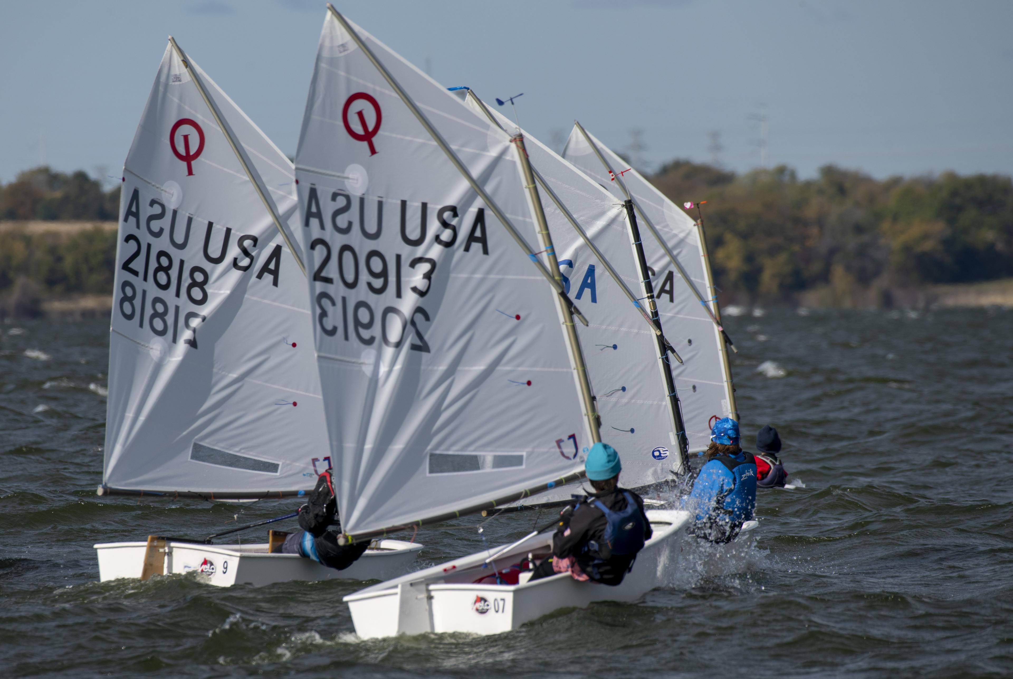 Junior sailors racing Optimist dinghies on Lake Ray Hubbard