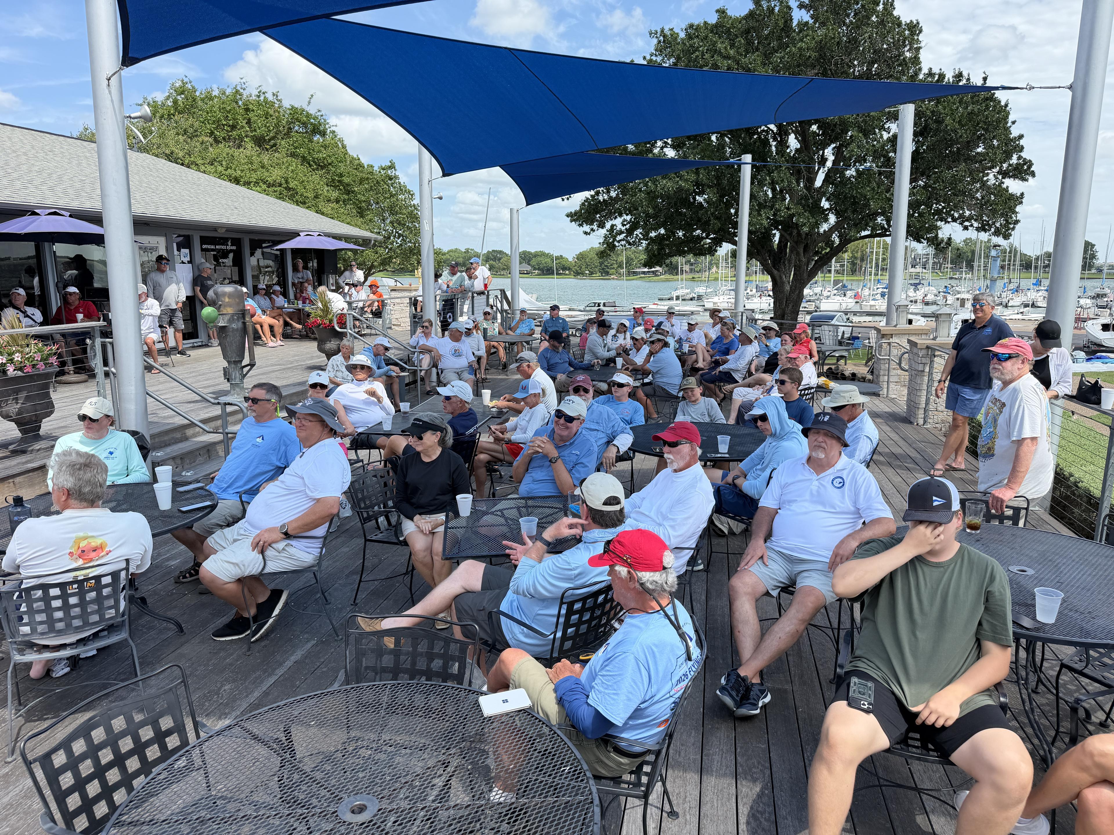 Crowd of sailors gathered on the Rush Creek Yacht Club deck for a regatta