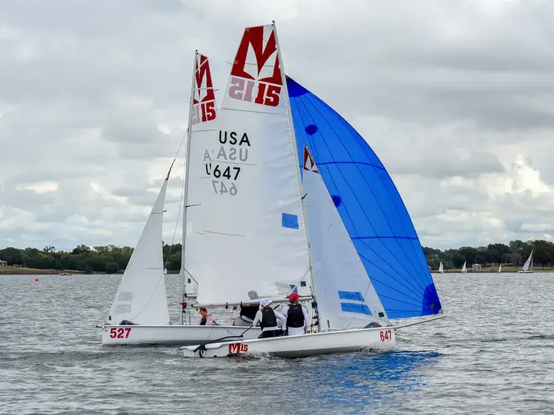 Melges 15 sailing downwind under a blue spinnaker