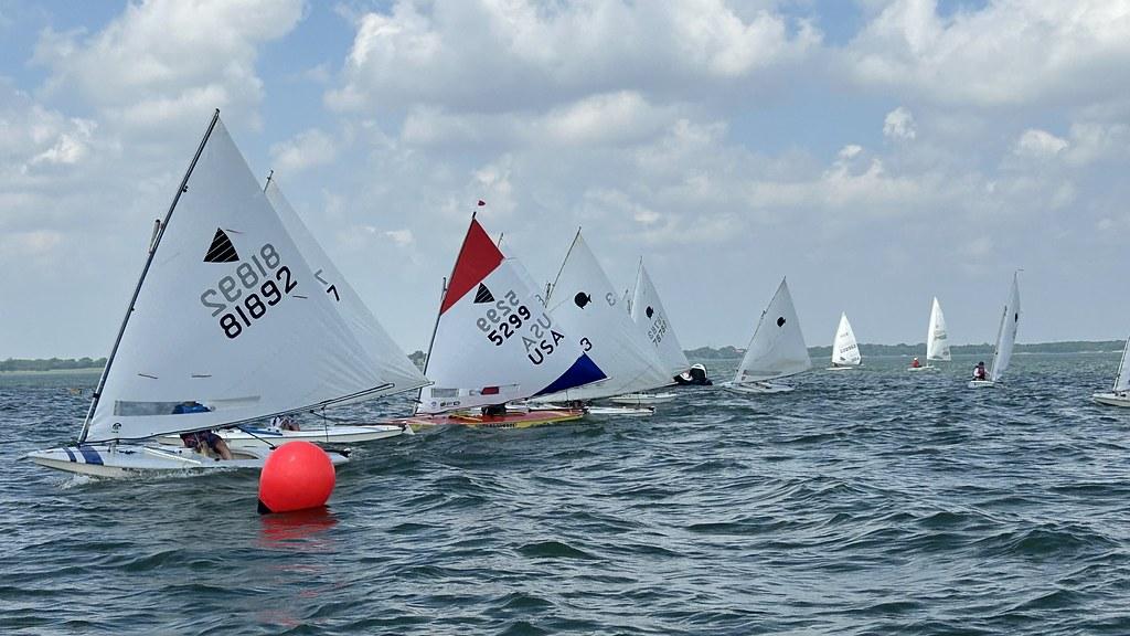 Sunfish fleet rounding a red mark during racing on Lake Ray Hubbard