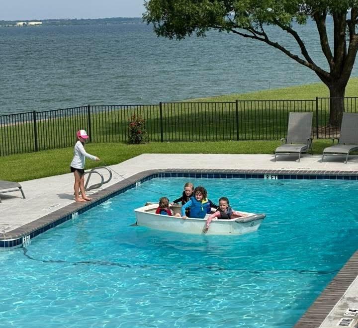 Young Tadpoles sailors in a boat in the Rush Creek pool overlooking Lake Ray Hubbard