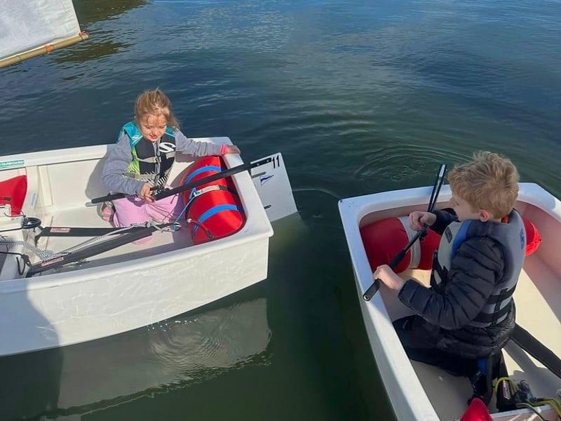 Two young sailors in small boats during a Rush Creek youth sailing session