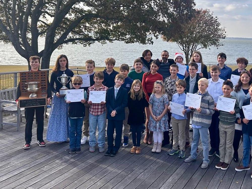 Rush Creek youth sailing group with awards on the clubhouse deck